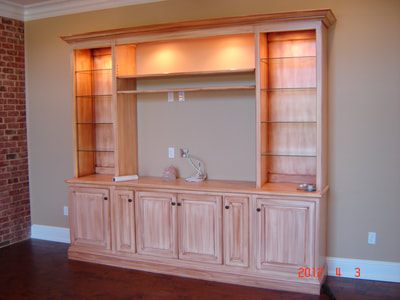Solid Maple with Glazed Finish.Glass shelves and lights shining down .Pullout media storage.